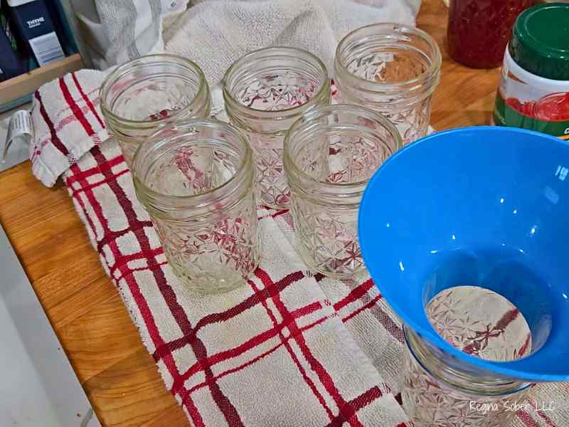 half pint canning jars, towel, canning funnel