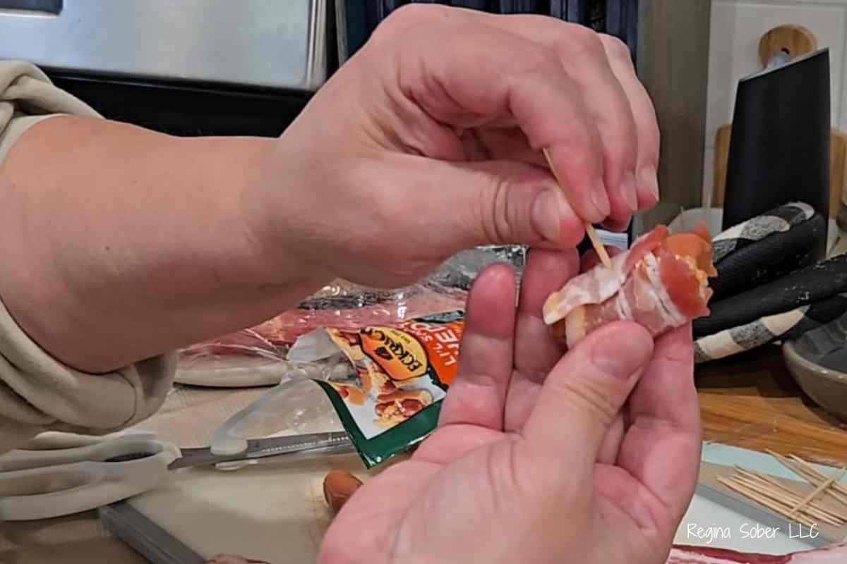 bacon wrapped around little sausages with a toothpick