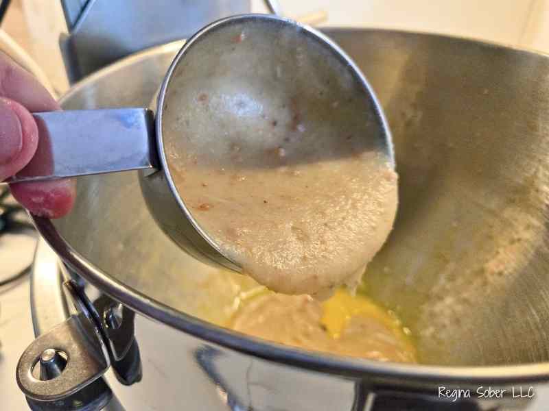 adding brown butter into mixing bowl