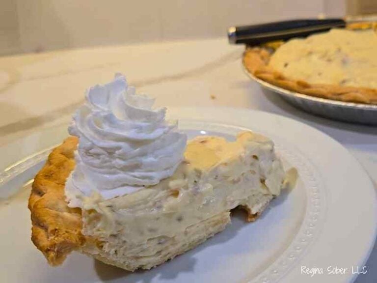 slice of coconut cream pie with whipped topping chilled and plated