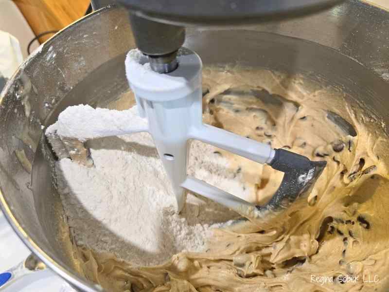 adding flour into cookie dough